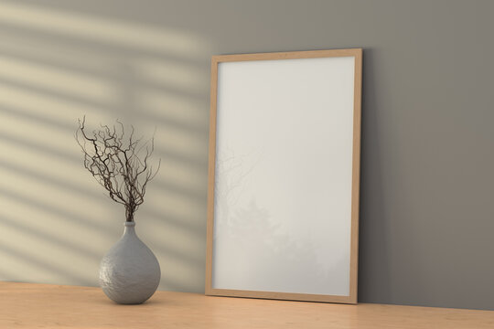 vertical wooden frame mock up on wooden shelf ot desk and gray wall