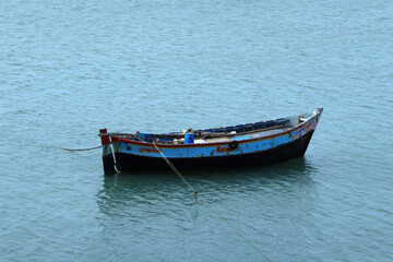 Fototapeta na wymiar Parked friendless fisher rowboat