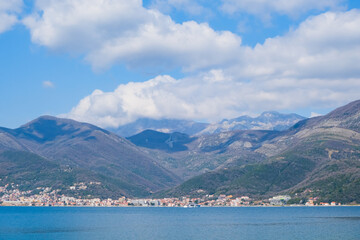 Fototapeta na wymiar view of the Kotor bay, Montenegro among mountains and clouds in blue sky. beautiful panorama coastline landscape. travel destination