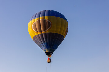 Hot air balloon flying over the Nur-Sultan on a cloudless summer's day.
