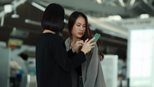 Two Asia women take a photo in the airport