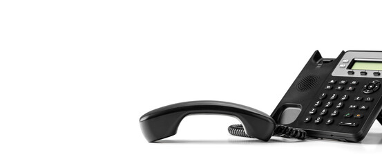 contact us. Close up telephone devices at office desk for customer service. telephone VOIP. black office voip phone with handset up isolated on white background