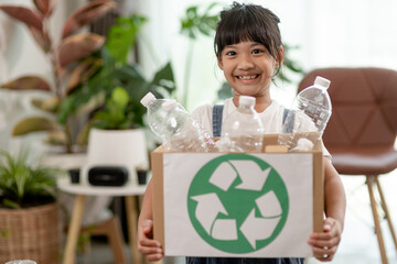 Asian Little girl is separate trash to recycle
