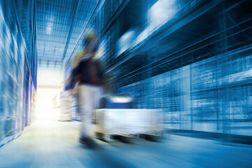 Blurred Warehouse For Industrial or Logistics Background. Interior Warehouse Space Storage of Tall...