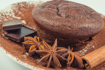 Fresh chocolate muffins and ingredients on plate. Delicious dessert