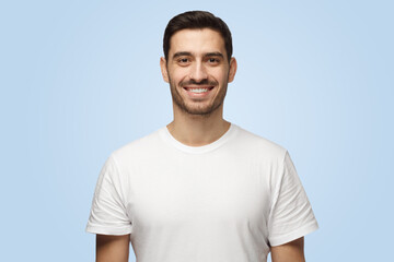 Young attractive European man looks straight at camera with happy smile