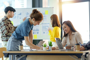 Group Young Asian business people with the creative work, talk and exchange ideas shared at the meeting.