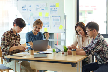 Group Young Asian business people with the creative work, talk and exchange ideas shared at the meeting.