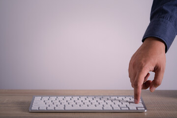 businessman hand finger pressing button enter key on laptop keyboard. copy space for text.