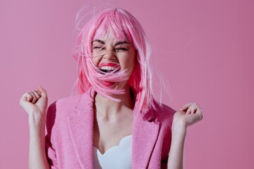 Positive young woman in a pink blazer pink wig cropped view pink background unaltered - obrazy, fototapety, plakaty