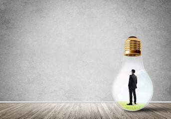 Obraz premium Businessman trapped in bulb