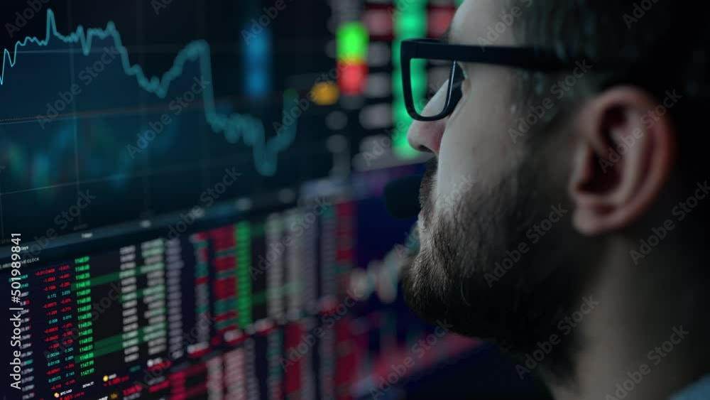 Poster trader is working with multiple computer screens full of charts and data analysis and stock broker t