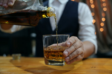 Barman pouring whiskey whiskey glass beautiful night