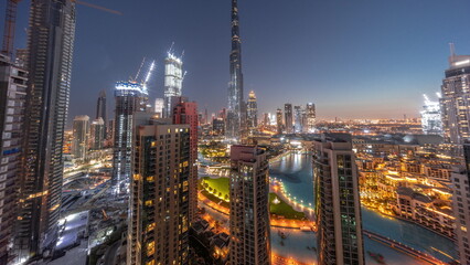 Fototapeta na wymiar Dubai Downtown cityscape with tallest skyscrapers around aerial night to day timelapse.