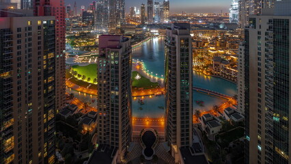 Dubai Downtown cityscape with tallest skyscrapers around aerial night to day timelapse.