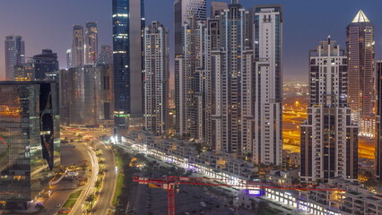 Fototapeta na wymiar Bay Avenue with modern towers residential development in Business Bay aerial night to day timelapse, Dubai