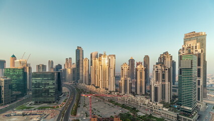 Obraz premium Bay Avenue during sunrise with modern towers in Business Bay aerial panoramic timelapse, Dubai