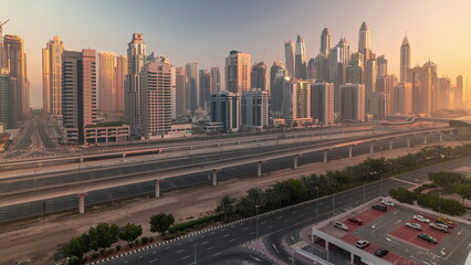 Fototapeta na wymiar Dubai marina tallest block of skyscrapers morning timelapse.
