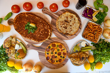  Traditional Turkish cuisine. Pizza, pita, pidesi, sucuk, hummus, kebab. Many dishes on the table. Serving dishes in restaurant. Background image. Top view, flat lay