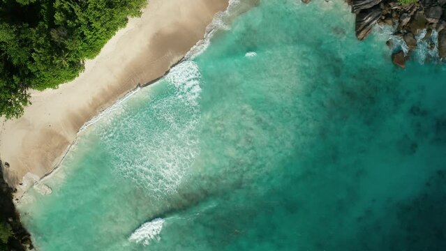 Flat aerial lift up over a paradise secluded Anse Du Riz beach, Mahe