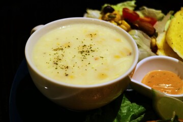 White soup bowl filled with corn chowder