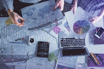 Double exposure of man and woman working together and financial chart hologram drawing. market analysis concept. Computer background. Top View.