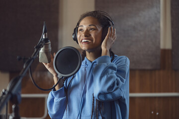 Female singer records new song. Emotional actress voices text, rehearses with enjoyment and...