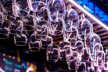 Glasses for wine and cocktails hanging over the bar