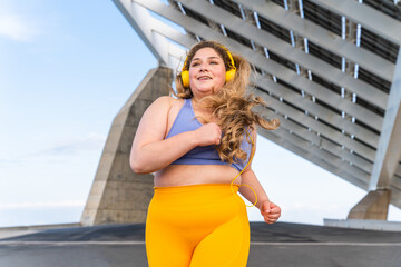Beautiful plus size young woman outdoors, concepts about body acceptance, body positive and self...