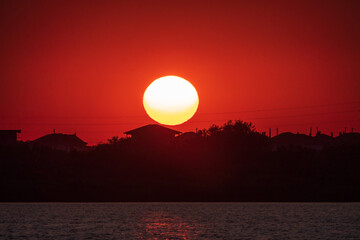 The sun goes down over a lake