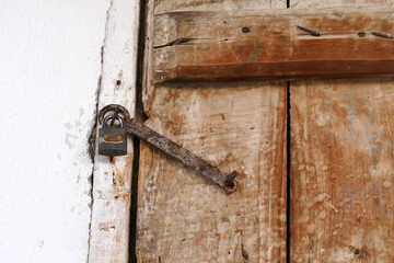 wooden door and there is a lock on it, the old classic house door with the lock