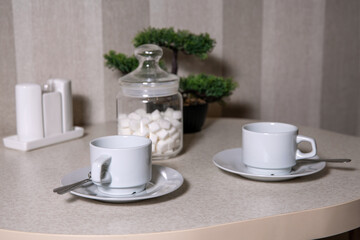 white cups of sugar in a jar on the table