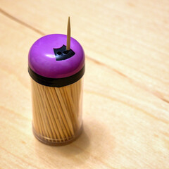 Jar with toothpicks on the table close up