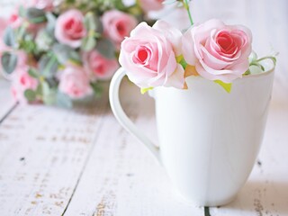 White cup of tea with pink rose on pink background ,Valentine's day romantic ,Mother's day ,pretty background or wallpaper ,soft selective focus ,wedding card design ,coffee cup ,lovely love card 