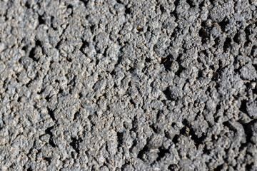 Porous concrete close up macro shot for industrial background on a sunny day.