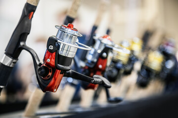 an assortment of fishing reels on the counter of a fishing shop - 502007070