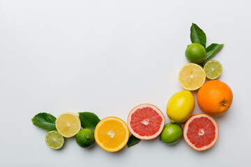 Fruit background. Colorful fresh fruits on colored table. Orange, lemon, grapefruit Space for text healthy concept. Flat lay, top view, copy space