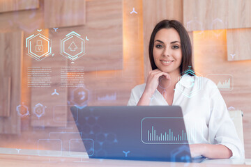 Attractive businesswoman in white shirt at workplace working with laptop to optimize development by...