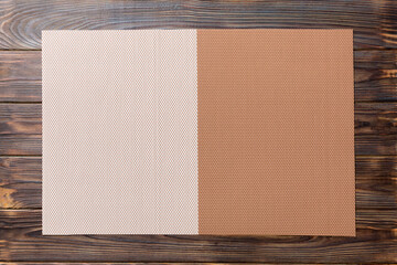 Top view of brown tablecloth for food on wooden background. Empty space for your design