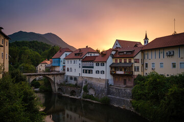 Fototapeta na wymiar Skofja Loka sunset with Sora river and Stone bridge