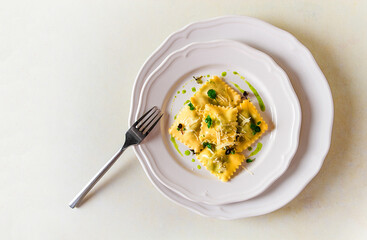 Ravioli with spinach and cheese, green sauce, on a light background, selective focus, no people,