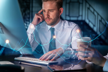 Two colleagues in formal wear working together to optimize trading strategy at corporate finance fund. Forex chart hologram over modern office background