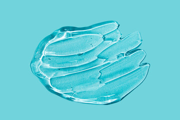 Transparent smear of Gel on blue background. Liquid hyaluronic acid gel.