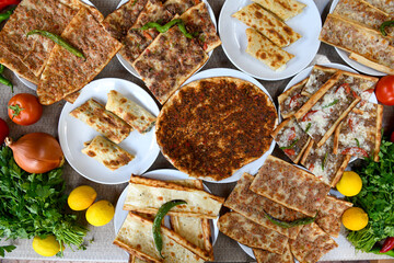  Traditional Turkish cuisine. Pizza, pita, pidesi, sucuk, hummus, kebab. Many dishes on the table. Serving dishes in restaurant. Background image. Top view, flat lay