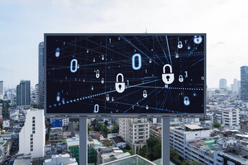 Padlock icon hologram on road billboard over panorama city view of Bangkok at day time to protect business, Southeast Asia. The concept of information security shields.