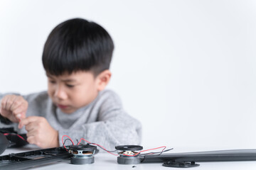 Fototapeta na wymiar Asian boy connecting speaker wires