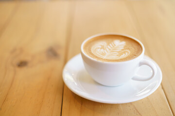 Cup of coffee with fern tree pattern milk foam