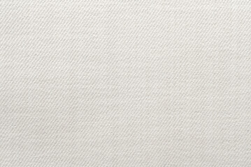 Light gray fabric background. Luxurious piece of white material for tailoring