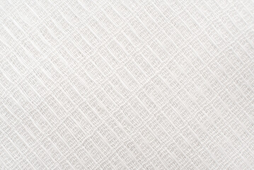 Light gray fabric background. Luxurious piece of white material for tailoring