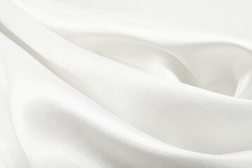 A twisted piece of white fabric. White material or texture with waves and folds. Wrinkled white...